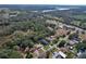 Aerial view of neighborhood highlighting proximity to water, roads, and nearby park and boat ramp at 27622 Lois Dr, Tavares, FL 32778