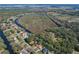 Aerial view of a property surrounded by trees with water access at 27622 Lois Dr, Tavares, FL 32778