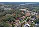 Annotated aerial view of neighborhood highlighting proximity to park, boat ramp, shops and restaurants at 27622 Lois Dr, Tavares, FL 32778