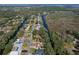 Aerial shot features a home with tree coverage close to the canal, showcasing neighborhood at 27622 Lois Dr, Tavares, FL 32778