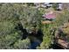 Aerial view of home with dock access through a treed area at 27622 Lois Dr, Tavares, FL 32778