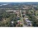 Aerial view of neighborhood highlighting proximity to water, roads, and nearby shops and restaurants at 27622 Lois Dr, Tavares, FL 32778