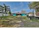 Spacious backyard featuring a metal roof home and boat trailer at 27622 Lois Dr, Tavares, FL 32778