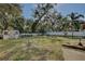 Large backyard with a storage shed and partially fenced with a white picket fence at 27622 Lois Dr, Tavares, FL 32778