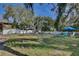 Large backyard with a storage shed and partially fenced with a white picket fence at 27622 Lois Dr, Tavares, FL 32778