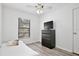 Bright bedroom with a modern dresser, ceiling fan, and natural light from the window at 27622 Lois Dr, Tavares, FL 32778