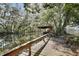 Beautiful waterfront scenery with a private boat dock on calm waters surrounded by trees draped with Spanish Moss at 27622 Lois Dr, Tavares, FL 32778