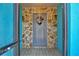 Close-up of a stone-framed entrance featuring a gray front door with a decorative wreath at 27622 Lois Dr, Tavares, FL 32778