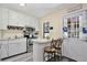 Cozy kitchen featuring white cabinetry, stainless steel appliances, and a breakfast bar with seating at 27622 Lois Dr, Tavares, FL 32778