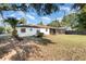 Landscaped backyard with screened porch and grassy area at 306 Loch Low Dr, Sanford, FL 32773