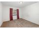 Empty bedroom with window and maroon curtains at 306 Loch Low Dr, Sanford, FL 32773