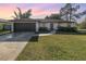 House exterior featuring a garage and lawn at 306 Loch Low Dr, Sanford, FL 32773