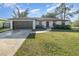 Single-story house with a brown garage door and well-maintained lawn at 306 Loch Low Dr, Sanford, FL 32773