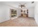 Open living room with view to kitchen and sliding door to patio at 306 Loch Low Dr, Sanford, FL 32773