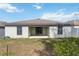 Exterior view of home's backyard, featuring a covered patio at 330 Pheasant Dr, Haines City, FL 33844