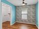 Bedroom showcasing a window with blinds, wood floors, and a ceiling fan at 330 Pheasant Dr, Haines City, FL 33844