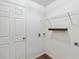 Bright laundry room with floating shelves and wood-look flooring at 330 Pheasant Dr, Haines City, FL 33844