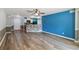 View of the spacious living room with wood-look flooring leading into the kitchen at 330 Pheasant Dr, Haines City, FL 33844