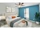 Stylish main bedroom featuring a calming color scheme, bench, and large window at 330 Pheasant Dr, Haines City, FL 33844