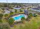 Aerial view of community pool with seating area, palm trees, and surrounding neighborhood at 3337 Reedy Glen Dr, Kissimmee, FL 34758