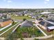 Aerial view of a neighborhood with solar panels on the roofs of several homes, and green lawns at 3337 Reedy Glen Dr, Kissimmee, FL 34758