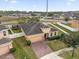 Aerial view of a charming home featuring a well-manicured front yard, a private driveway, and a two-car garage at 3337 Reedy Glen Dr, Kissimmee, FL 34758