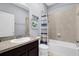 Cozy bathroom featuring a vanity with granite countertop, a toilet, and a shower-tub combo with blue striped curtain at 3337 Reedy Glen Dr, Kissimmee, FL 34758