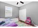 Bright bedroom featuring a ceiling fan, a window letting in natural light, and a colorful play area at 3337 Reedy Glen Dr, Kissimmee, FL 34758