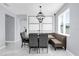 Dining area featuring marbled tile floors, modern table with booth seating, statement light fixture, and natural light at 3337 Reedy Glen Dr, Kissimmee, FL 34758