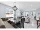 Bright open-concept dining area with modern lighting and seamless flow to the living room at 3337 Reedy Glen Dr, Kissimmee, FL 34758