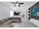 Open-concept living room with accent wall, sleek shelving, and seamless flow to the modern kitchen at 3337 Reedy Glen Dr, Kissimmee, FL 34758