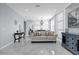 Bright living room featuring white marbled tile floors, modern furnishings, and decorative wall accents at 3337 Reedy Glen Dr, Kissimmee, FL 34758