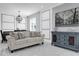 Living room with white tile floors, modern decor, beige couch, dark wood dining table, and statement light fixture at 3337 Reedy Glen Dr, Kissimmee, FL 34758