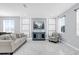 Bright living room featuring white marbled tile floors, modern furnishings, decorative wall accents, and natural light at 3337 Reedy Glen Dr, Kissimmee, FL 34758