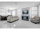 Living room with white tile floors, modern decor, beige couch, dark wood dining table, and statement light fixture at 3337 Reedy Glen Dr, Kissimmee, FL 34758