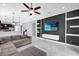 Spacious living room with stylish accent wall, sleek shelving, and seamless flow to the modern kitchen at 3337 Reedy Glen Dr, Kissimmee, FL 34758