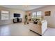 Living room with light beige walls, tile floors, and comfortable seating at 3813 Royal Azalea Way, Sanford, FL 32773