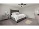 Stylish bedroom featuring a tufted headboard, mirrored nightstand, ceiling fan, and grey carpet at 4104 Southern Vista Loop, St Cloud, FL 34772