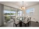 Dining area with modern light fixture and sliding glass doors that open to an outdoor patio at 4104 Southern Vista Loop, St Cloud, FL 34772