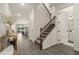 Bright entryway with modern staircase leading to the second floor and an open view into other living spaces at 4104 Southern Vista Loop, St Cloud, FL 34772