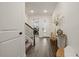 Inviting entryway featuring wood floors, staircase, console table, and bright natural light at 4104 Southern Vista Loop, St Cloud, FL 34772