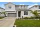 Two-story home featuring a manicured front lawn, attached two-car garage and a gray and white exterior at 4104 Southern Vista Loop, St Cloud, FL 34772