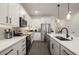 Modern kitchen with stainless steel appliances, white cabinets, granite countertops, and recessed lighting at 4104 Southern Vista Loop, St Cloud, FL 34772