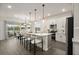 Eat-in kitchen with white cabinetry, stainless appliances, a center island and an adjacent dining area at 4104 Southern Vista Loop, St Cloud, FL 34772