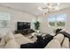 Comfortable living room with large windows for natural light and modern furniture, and adjacent to the kitchen at 4104 Southern Vista Loop, St Cloud, FL 34772