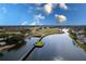 Stunning aerial view featuring a golf course, bridge and lake, showcasing a community amenity at 421 Boxwood Dr, Davenport, FL 33837