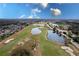 Aerial view of community golf course with lush green fairways, serene ponds, and beautifully landscaped grounds at 421 Boxwood Dr, Davenport, FL 33837