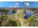 Scenic aerial view of golf course with winding fairways, tranquil ponds, and lush greenery offering a picturesque landscape at 421 Boxwood Dr, Davenport, FL 33837