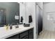 This is a bathroom with a white countertop, dark cabinets, and a shower/tub combo with a gradient shower curtain at 421 Boxwood Dr, Davenport, FL 33837