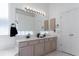 Elegant bathroom with double sinks, a large mirror, and ample counter space at 421 Boxwood Dr, Davenport, FL 33837